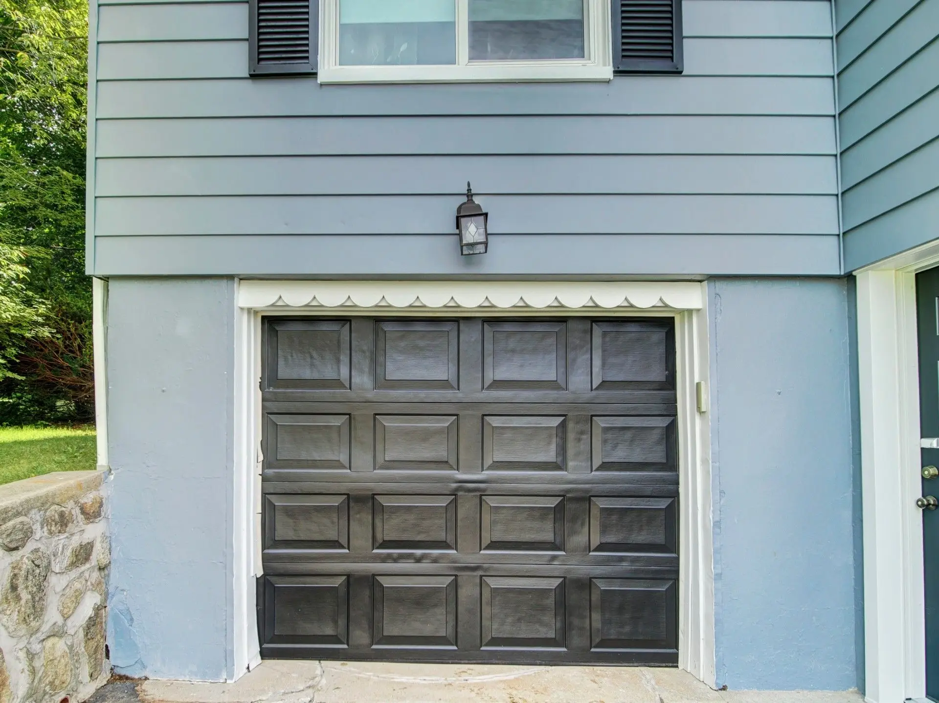 Close-up of painted black garage door and white trim on Netcong NJ home