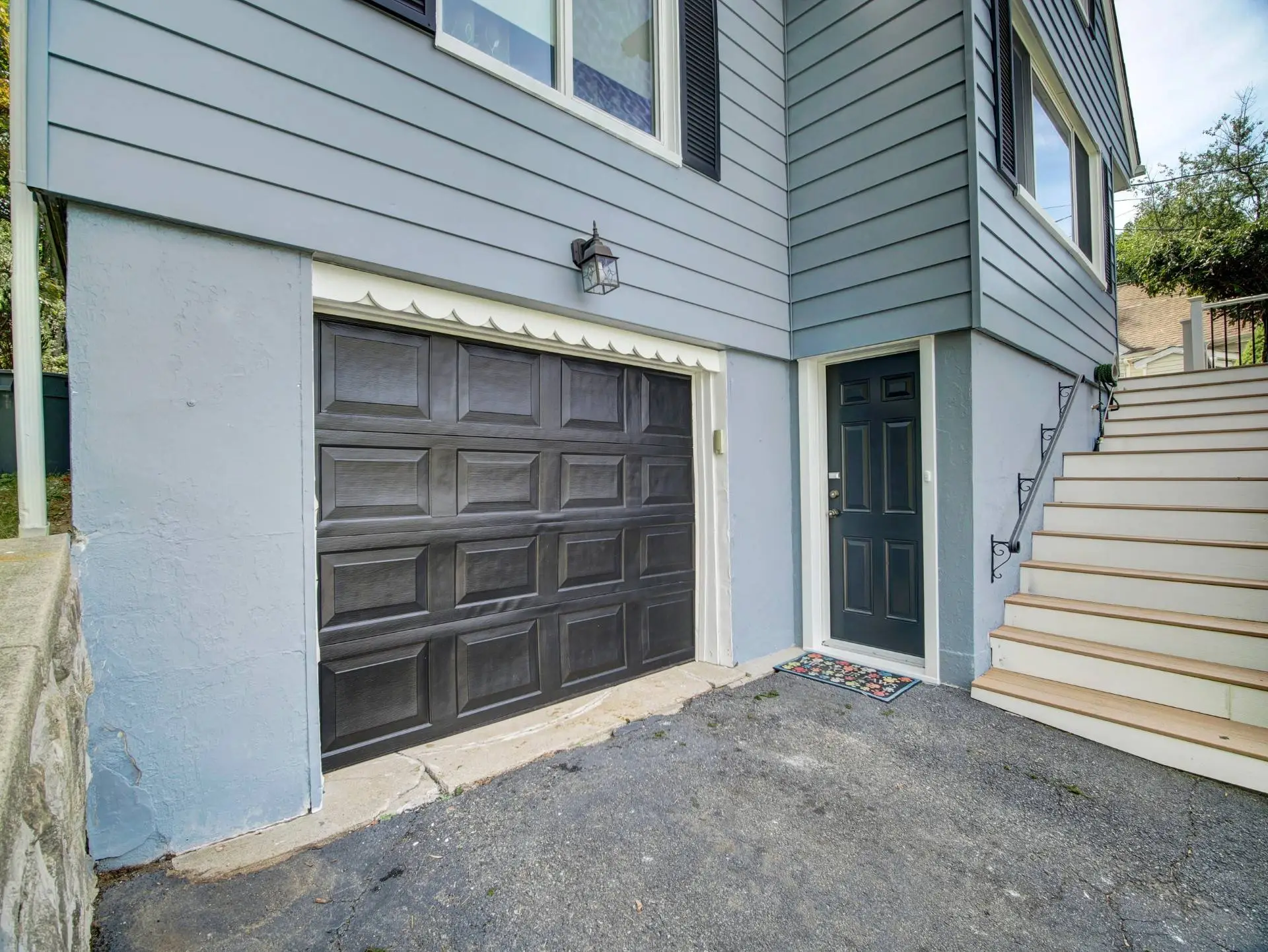 Exterior painted garage door, trim and stucco foundation on Netcong NJ home