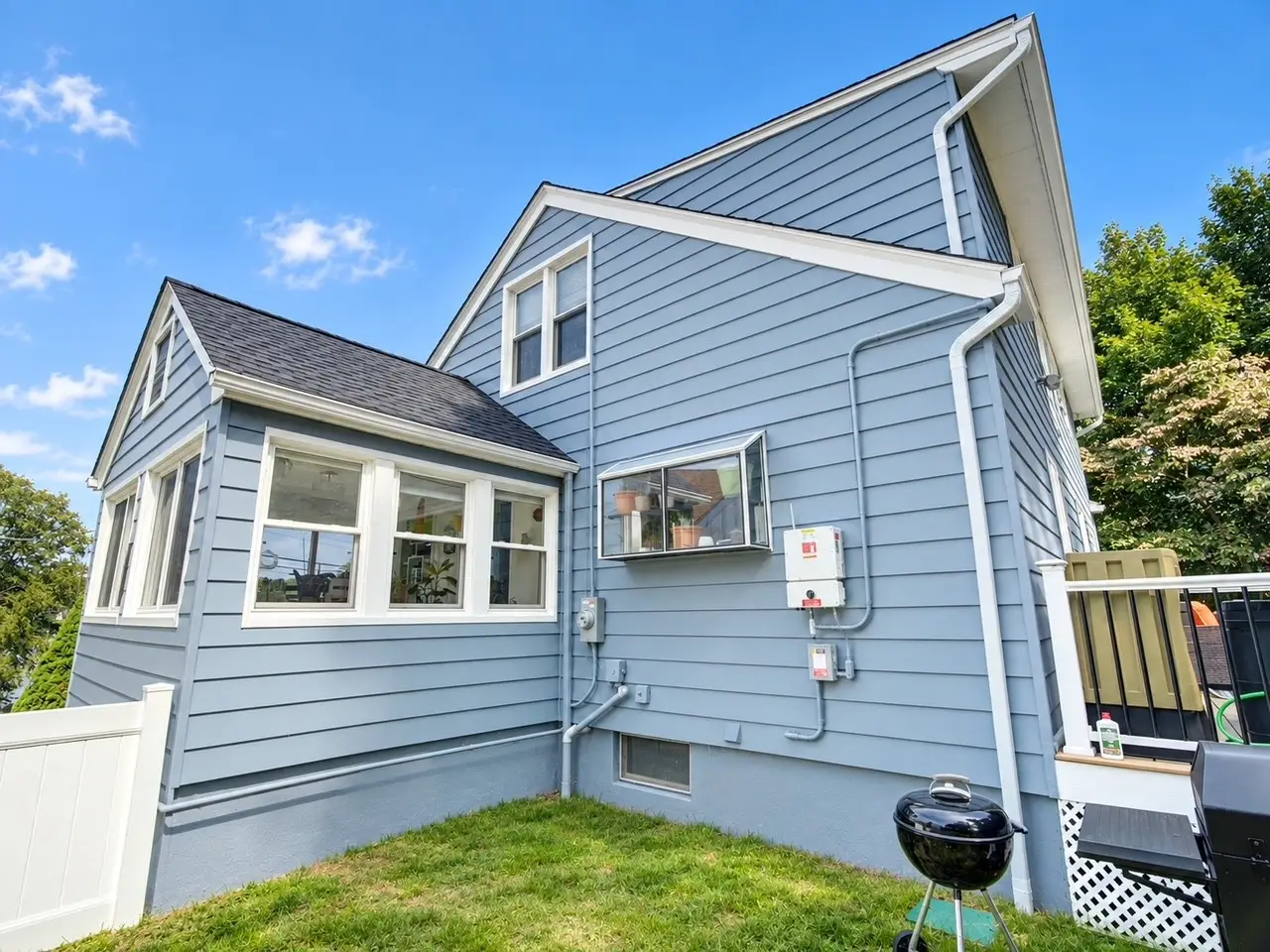 Side view of painted blue siding, white trim and sunroom on Netcong NJ home